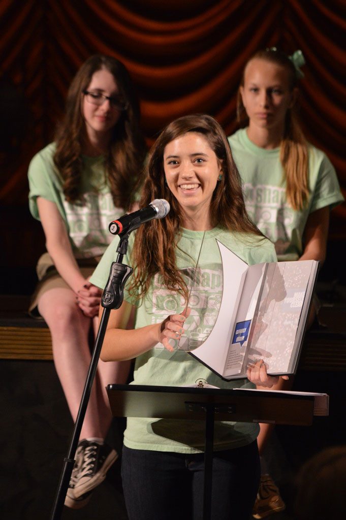 Editor-In-Chief Michela Diddle unveils the 2014 Secondary Yearbook